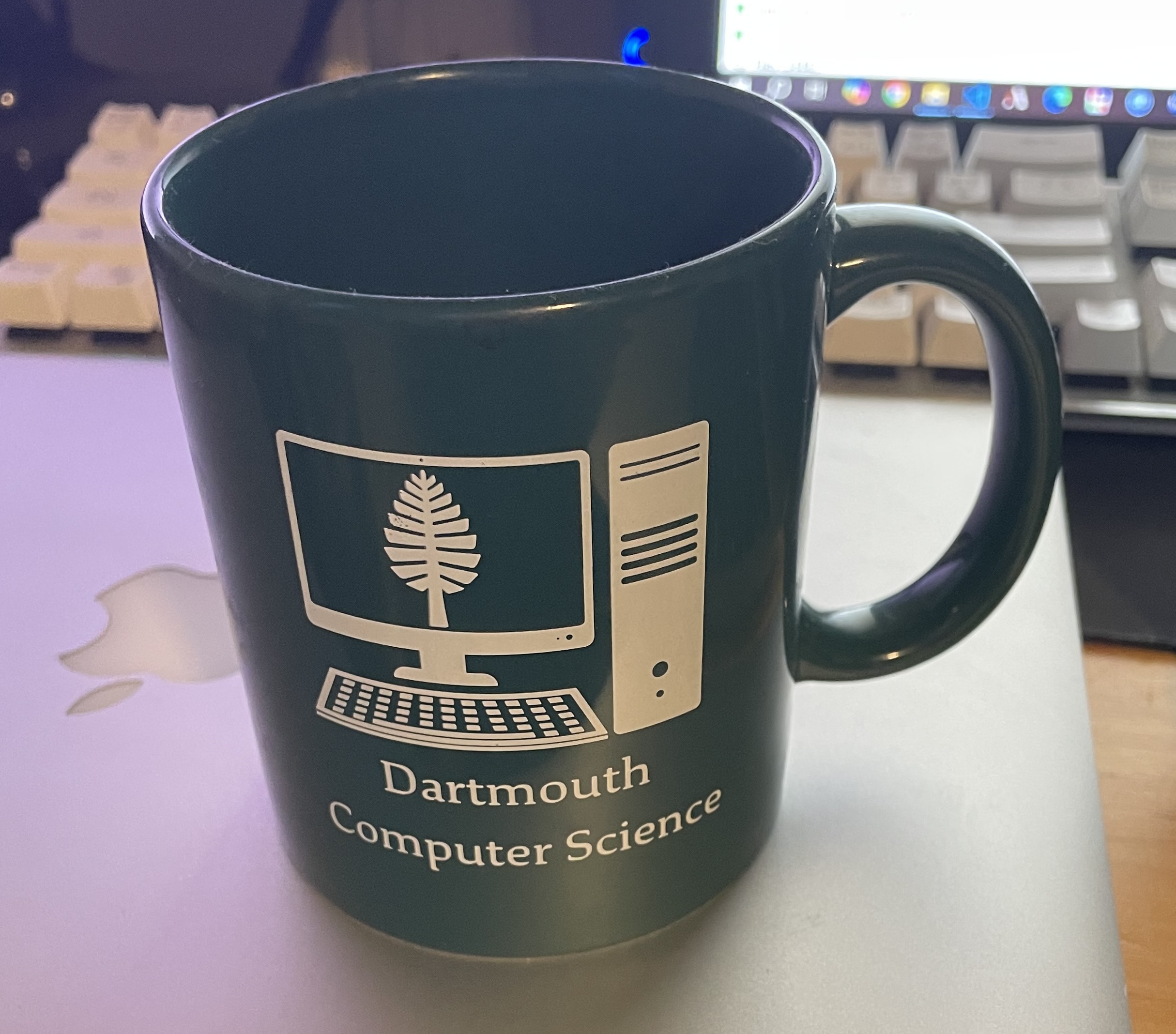 A cup with roughly two different materials, the green and white parts